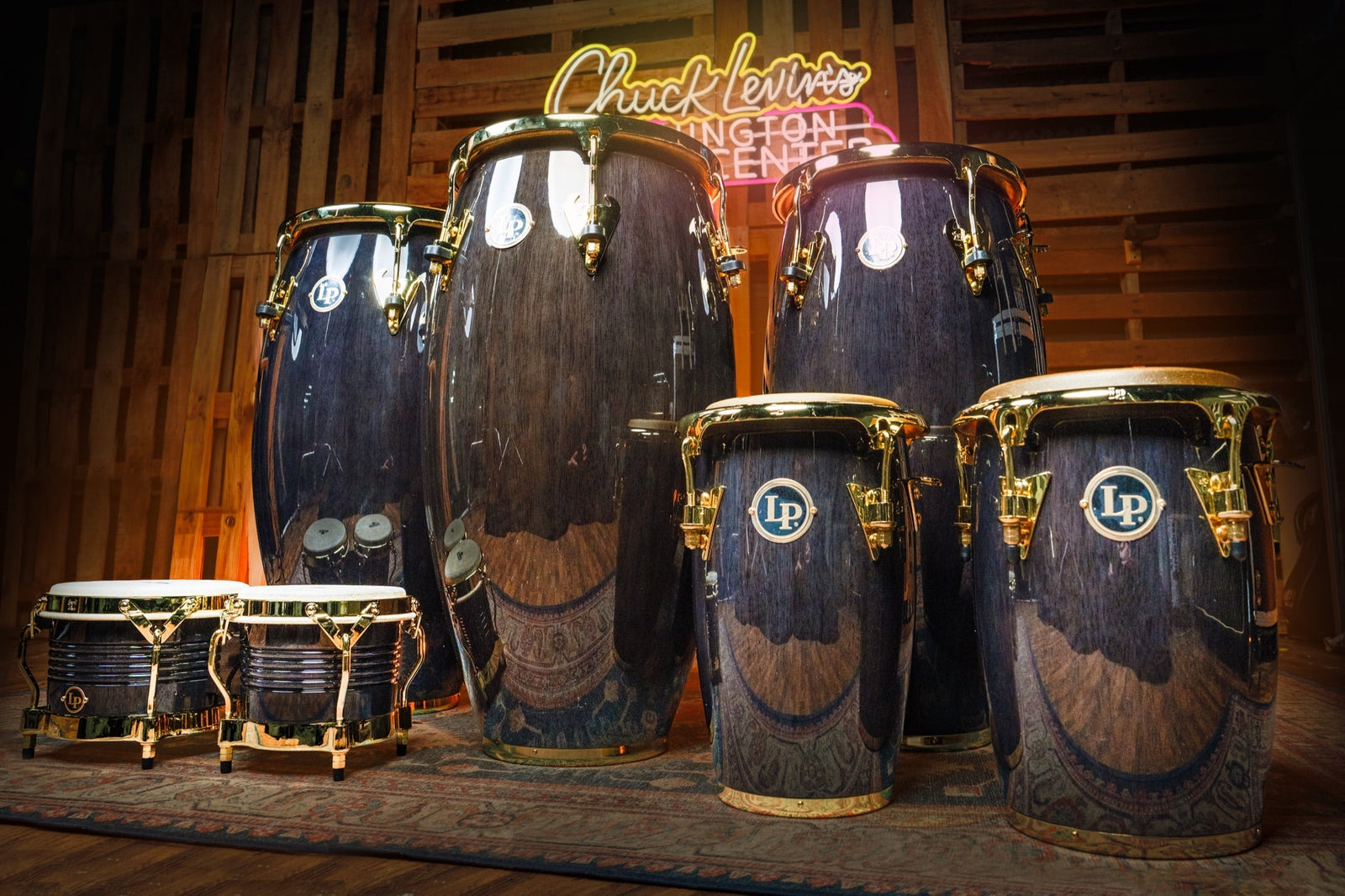 Latin Percussion Matador congas, bongos, and Junior congas in transparent black Siam Oak with gold hardware, a Chuck Levin's exclusive