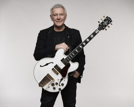 Alex Lifeson holding the Epiphone Alex Lifeson 1976 ES-355 Reissue in Alpine White