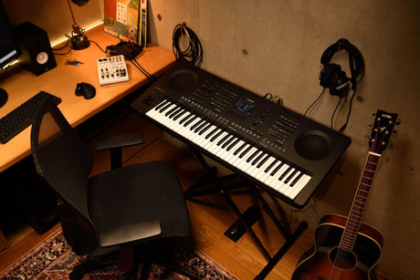 Yamaha PSR-SX620 61-key arranger keyboard on a stand in a home studio