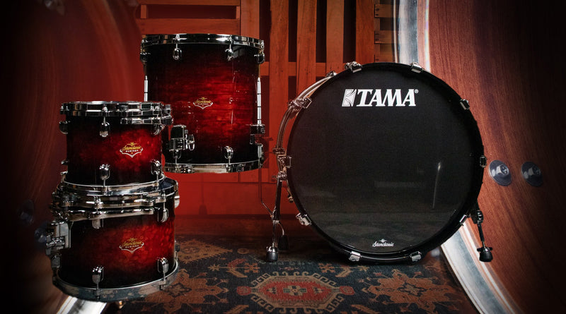 TAMA drums displayed against a wooden background