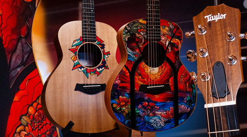 Three acoustic guitars with colorful designs on a dark background